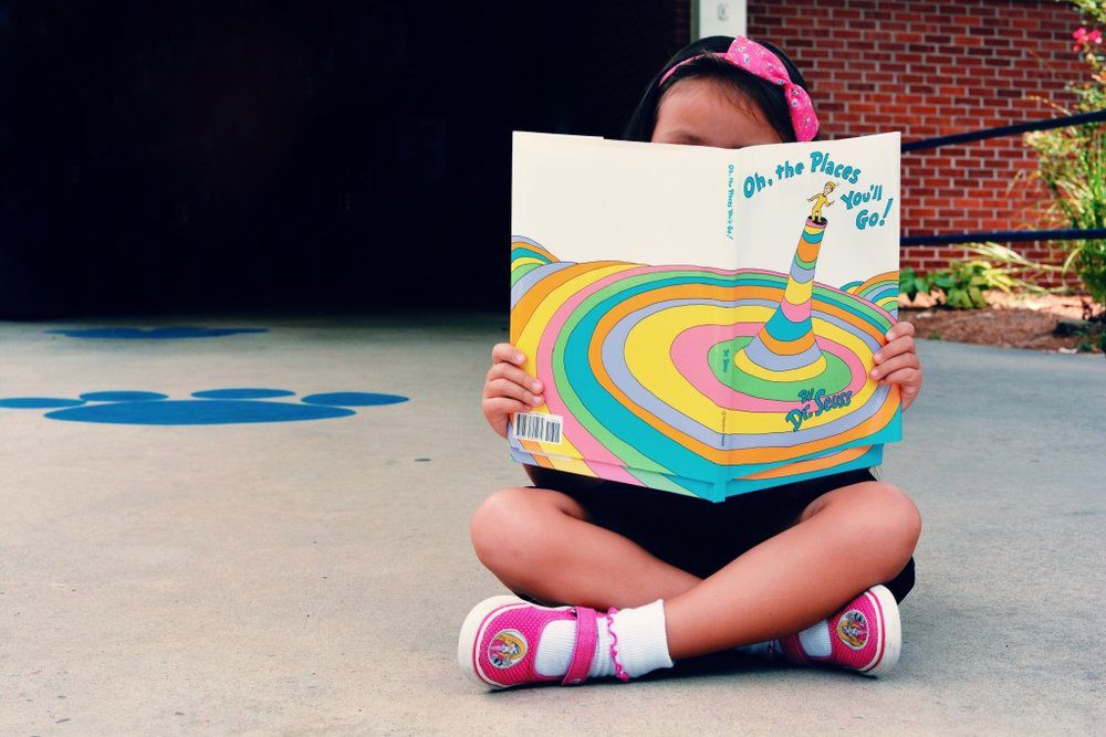 Child reading a Dr. Seuss book.