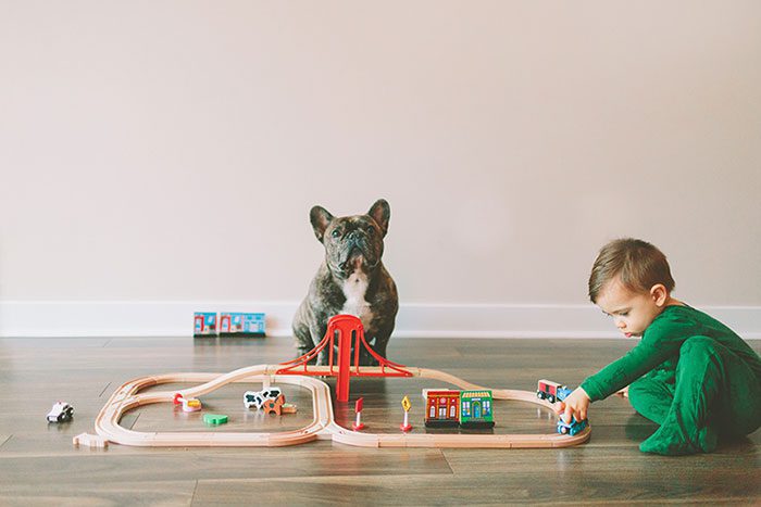 Child playing with wooden trains.