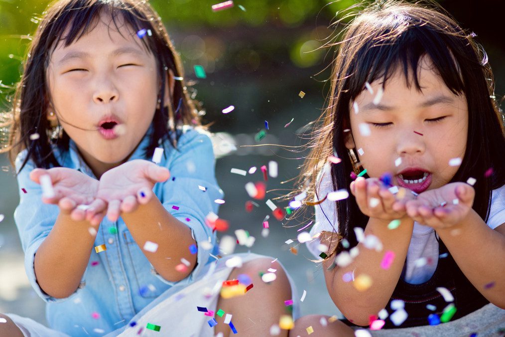 kids blowing confetti