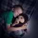 Small boy sleeping with a stuffed animal