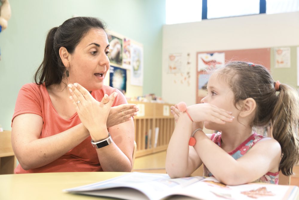 Special education teacher working with a young student