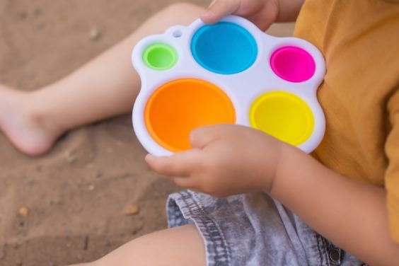 A child plays with sensory toys